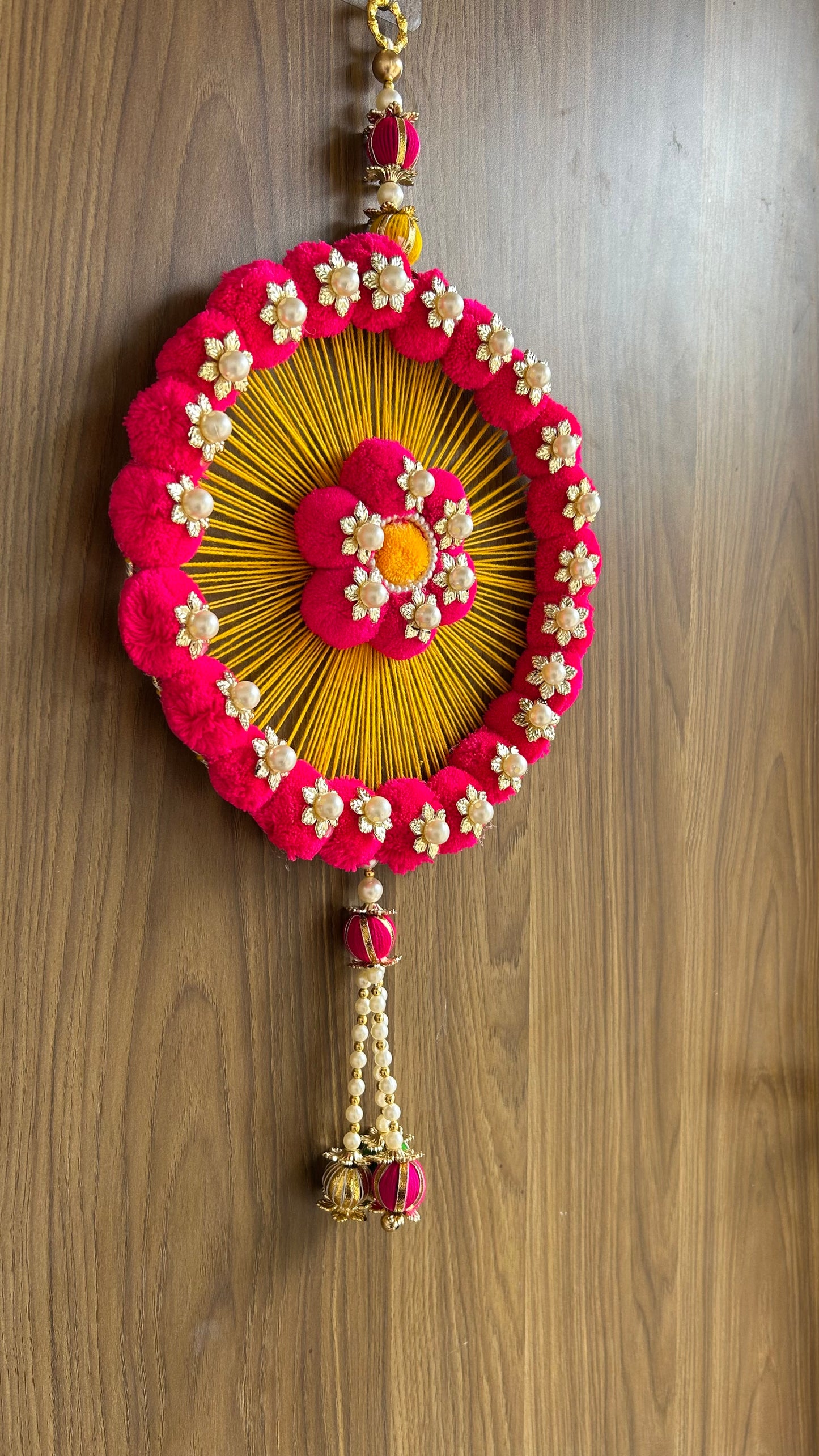 Kalakriti Handcrafted Floral Round Wall Hanging – Pink & Yellow Pom-Pom Decor with Pearl Accents for Home & Festive Decoration